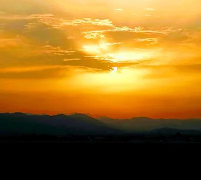 Sunset with storm clouds over mountains Stock Photos