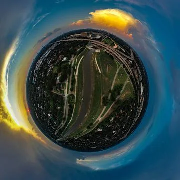 Sunset with a storm over river - tiny planet aerial image Stock Photos