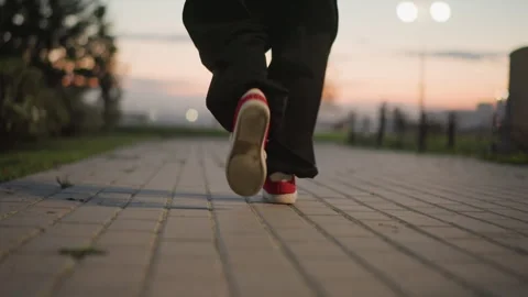 Sunset street dance training near cityscape lights at dusk, An artist perfects Stock Footage 325337754