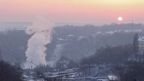 Sunset in the suburbs with smoke from a heat-generating plant in winter. Video stock 327229409