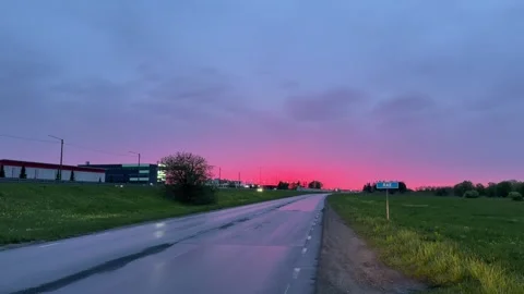 Sunset. Summer | 1 | Evening. A road. Cars moving in the distance  Stock Footage 336303200