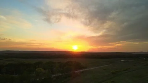 Sunset in summer over the forest and green fields, footage taken from the ai Stock Footage 246277560