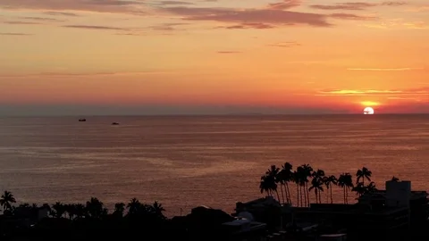 Sunset, sun halfway behind skyline Stock Footage 77973861