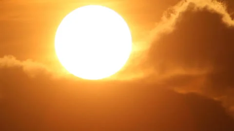 Sunset sun hides in dark clouds Stock Footage 125132247