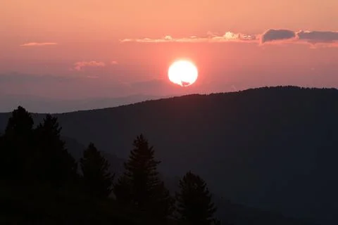 Sunset sun mountains clouds sky Stock Photos