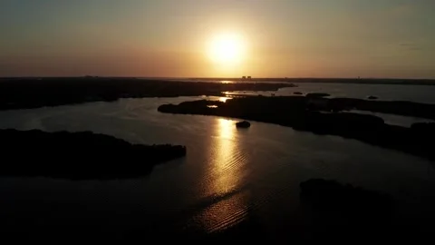 Sunset Sun Path Reflected on Wide Florida Wetland Lagoon from High Drone Stock Footage 338360753