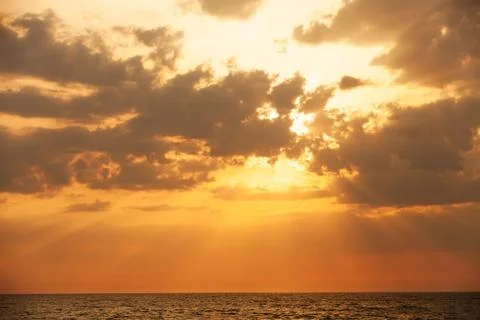 Sunset with sun rays and clouds Stock Photos