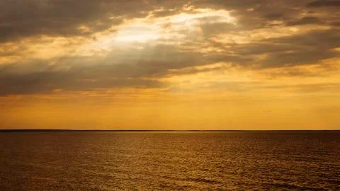 Sunset with sun rays and clouds Stock Photos