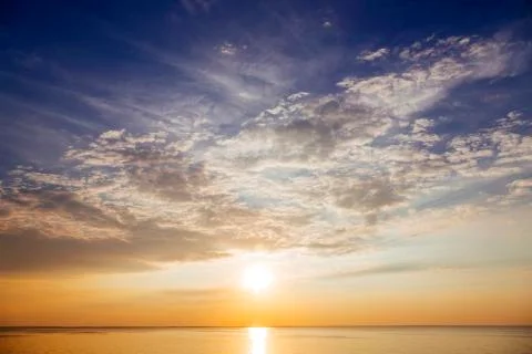 Sunset with sun rays and clouds Stock Photos