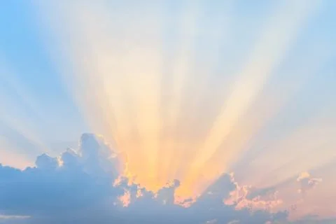 Sunset. Sun rays over the low clouds. Evening sky background. Stock Photos