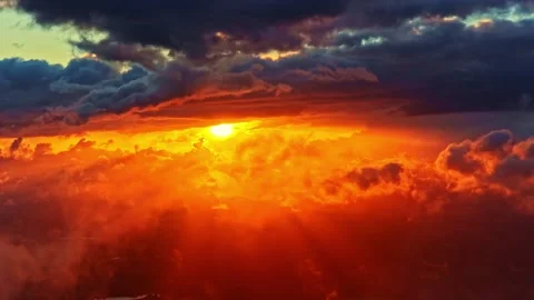 Sunset Sun Rays Shining Through Dramatic Clouds in Vibrant Orange Sky Stock Footage 341765655