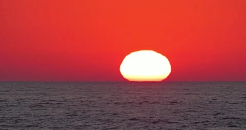 Sunset sun on red sky touches the sea horizon Stock Footage 298937059