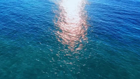 Sunset sun reflecting on sea surface. Blue wavy background. Stock Footage 295290313