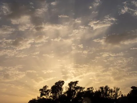 Sunset sun with a set of altocumulus clouds in the sky Fotos Stock