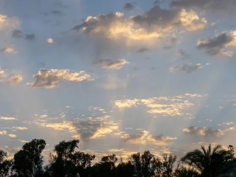 Sunset sun with a set of altocumulus clouds in the sky Stock Photos