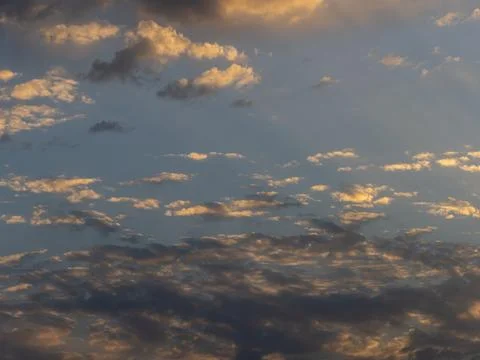 Sunset sun with a set of altocumulus clouds in the sky Fotos Stock