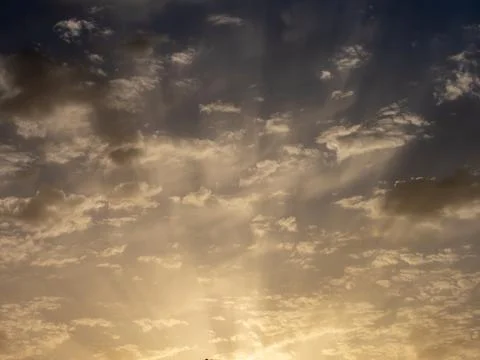 Sunset sun with a set of altocumulus clouds in the sky Stock Photos