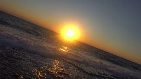 Sunset of sun setting over pacific ocean on windy evening Stock Footage 82010179