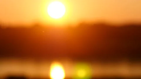 Sunset sun shines on the background of the lake. Close-up macro. Red setting sun 스톡 동영상 151665787