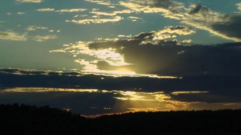 Sunset, sun through the black clouds, timelapse Stock Footage 80690030