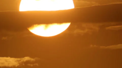 Sunset sun through line of cloud Stock-Footage 99824493