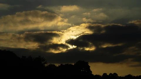 Sunset Sunbeams Through the Clouds Stock Photos