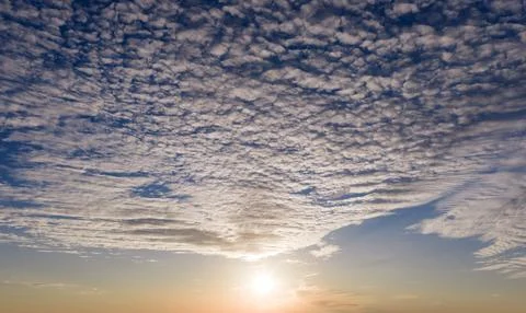 Sunset sunlight on clouds. Sunset in sky background. Sunset radiant evening.  Stock Photos