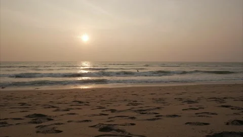 Sunset sunlight coastline beach view with sky movement and people passing. Video stock 140503835