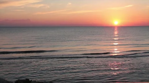 Sunset sunrise above water ocean lake with orange sky with zoom in Stock Footage 252153886