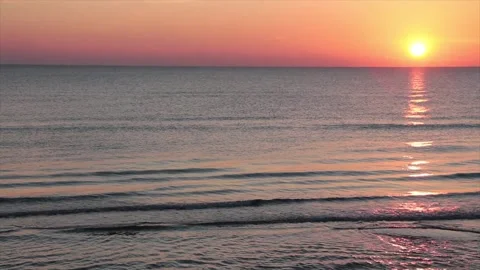 Sunset sunrise above water ocean lake with orange sky with zoom in and out Stock Footage 252153901