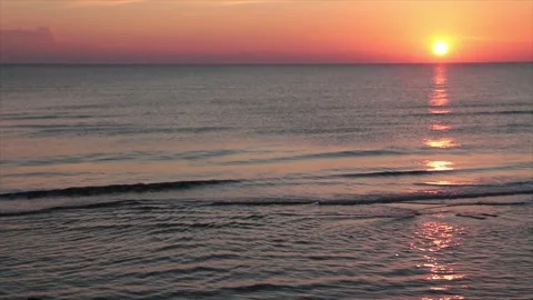 Sunset sunrise above water ocean lake with orange sky medium wide shot Vídeo Stock 252153932