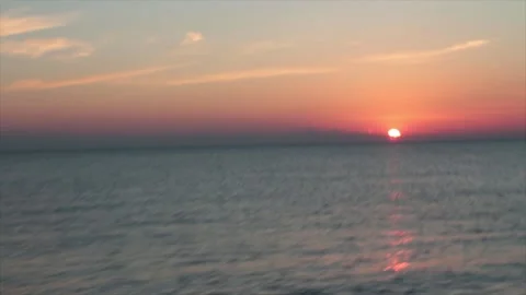 Sunset sunrise above water ocean lake with orange sky medium wide shot with zoom Stock-Footage 252153933