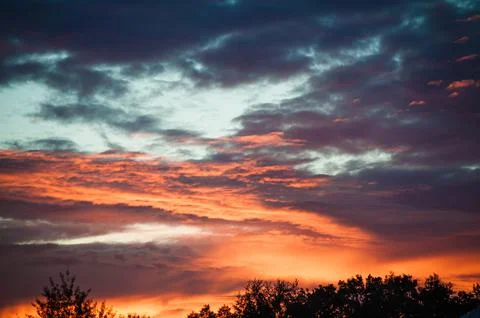 Sunset sunrise with clouds, light rays and other atmospheric effect Stock Photos