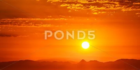 Sunset Sunrise Over Dark Mountain Silhouette. Sunshine Dramatic Stock Photos