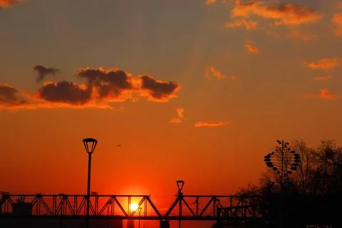 Sunset the sunset is red, against the background of the railway bridge, a Stock Photos