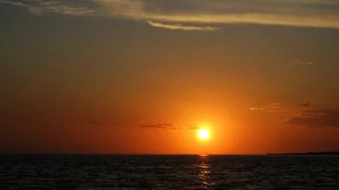 Sunset on the surface of sea Stock Photos