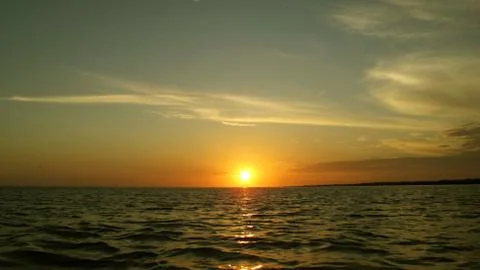 Sunset on the surface of sea Stock Photos