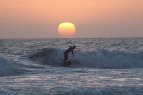 Sunset surfer alone Stock Photos