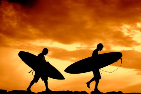 Sunset Surfers Stock Photos