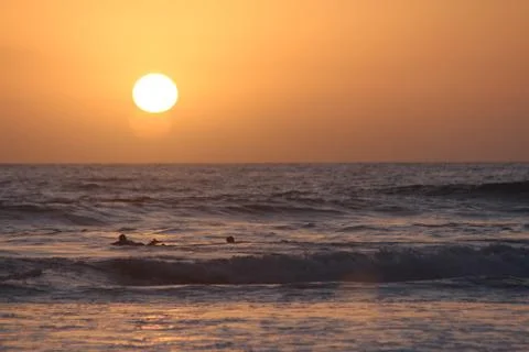 Sunset surfers Stock Photos