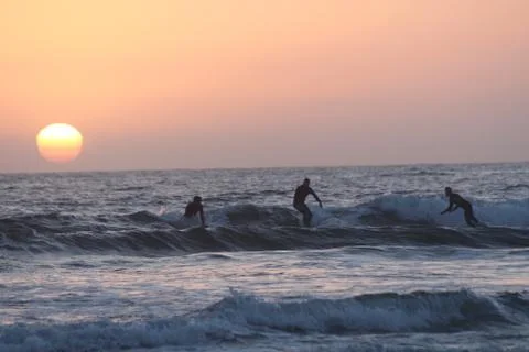 Sunset surfers Stock Photos