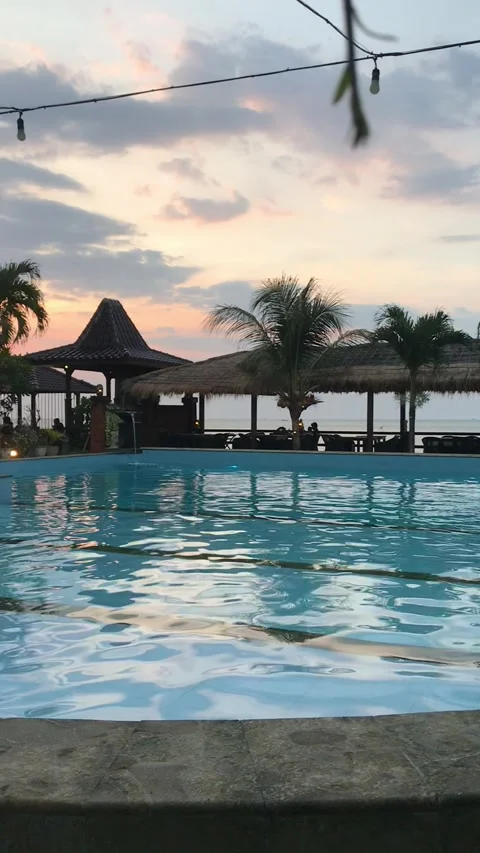 Sunset at the swimming pool resort Stock Footage 243442685