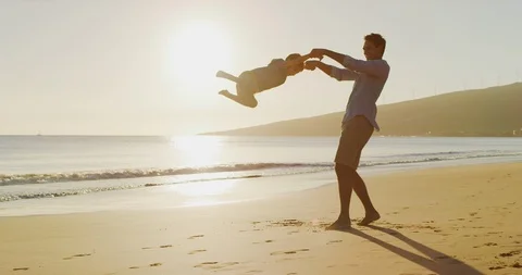 Sunset swings with dad at the beach Stock Footage 121691529