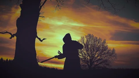 At sunset there is a grim Reaper Stock Footage 91297624