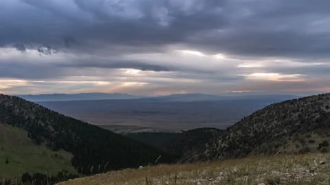 Sunset in thick rolling clouds colors shifting golden Stock Footage 167563824