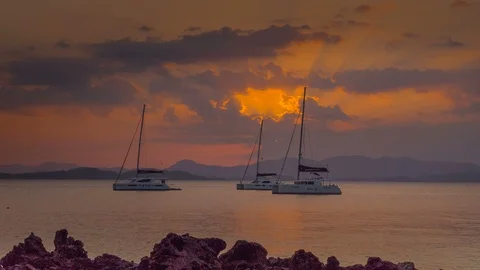 Sunset with three moored catamarans at sea Stock Footage 87817123