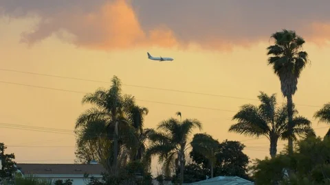 Sunset with three planes crossing frame. Stockbeeldmateriaal 89951037