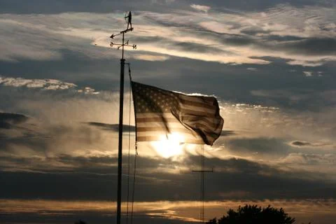 Sunset through American Flag Stock Photos