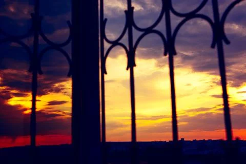 Sunset through the barred window Stock Photos