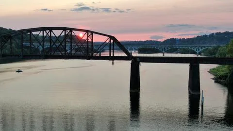 Sunset through a bridge and over a river in a valley in a small town in America Stock Photos